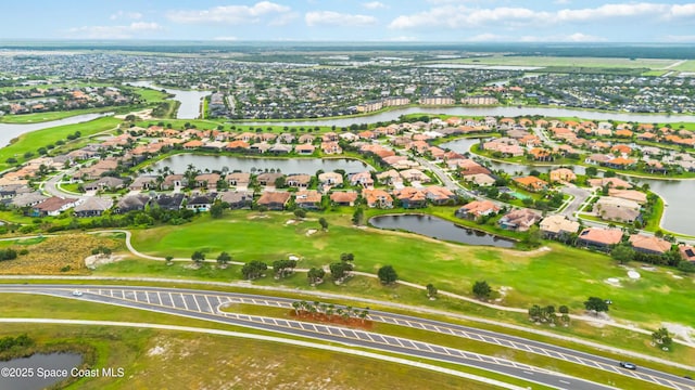 aerial view featuring a residential view, view of golf course, and a water view