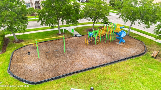view of home's community featuring a lawn and playground community