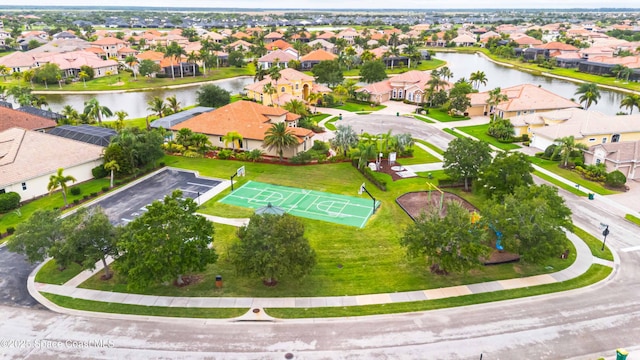 drone / aerial view featuring a water view and a residential view