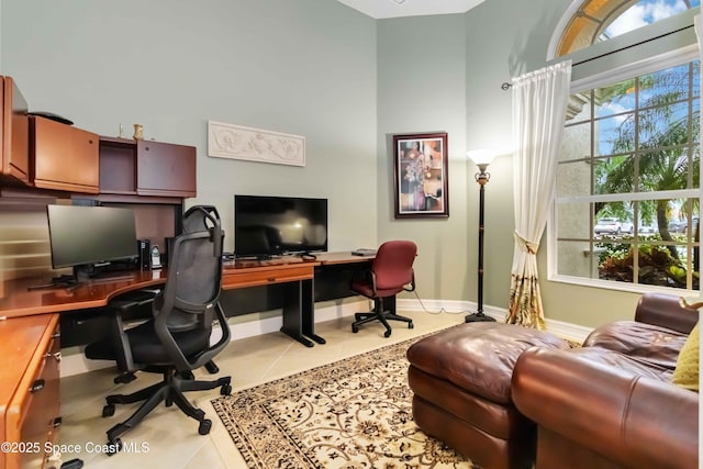 home office with baseboards and tile patterned flooring