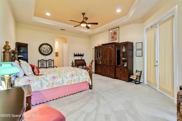bedroom featuring recessed lighting, arched walkways, carpet floors, and a raised ceiling