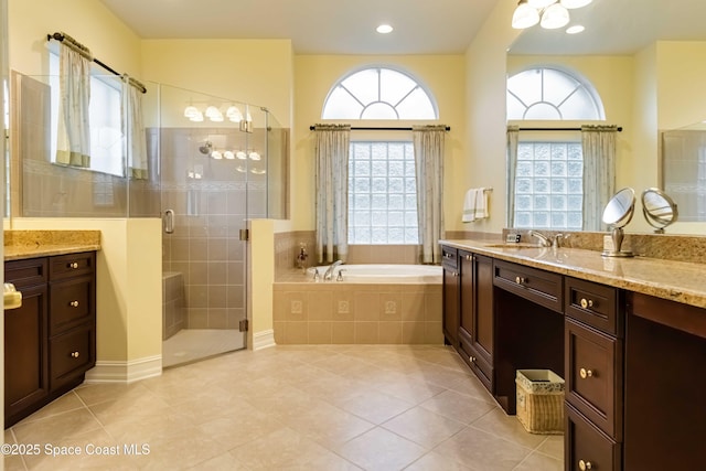 full bath with a shower stall, tile patterned flooring, vanity, and a garden tub