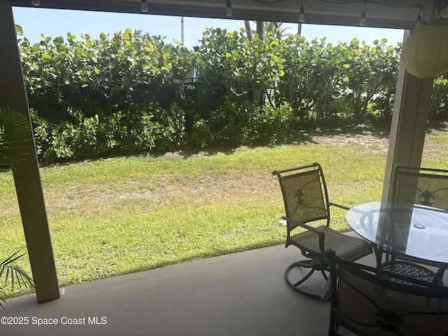 3170 N Atlantic Ave Unit 111, Cocoa Beach, FL 32931 - view of grassy yard featuring a patio