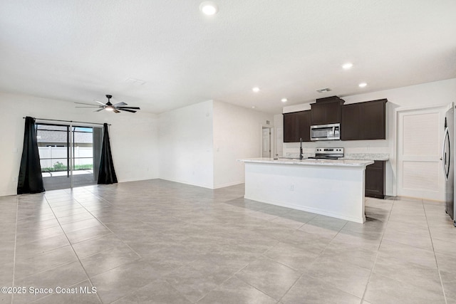 1217 Casey Ave, Rockledge, FL 32955 - kitchen with appliances with stainless steel finishes, light countertops, a center island with sink, a ceiling fan, and open floor plan