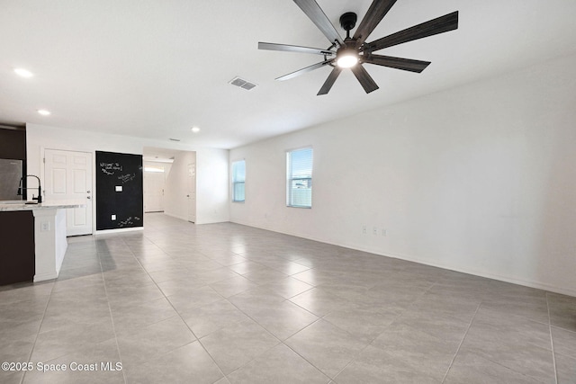 1217 Casey Ave, Rockledge, FL 32955 - unfurnished living room featuring a ceiling fan, light tile patterned floors, and recessed lighting
