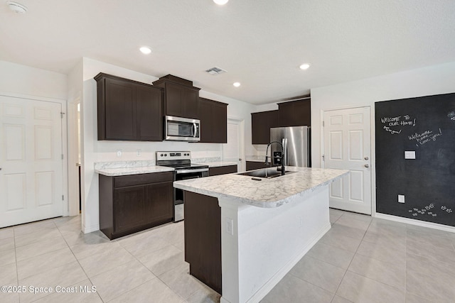1217 Casey Ave, Rockledge, FL 32955 - kitchen featuring appliances with stainless steel finishes, light countertops, light tile patterned floors, dark brown cabinetry, and recessed lighting