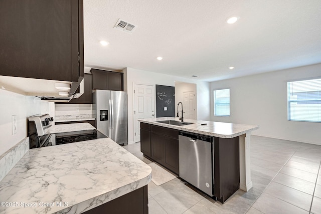 1217 Casey Ave, Rockledge, FL 32955 - kitchen featuring stainless steel appliances, light countertops, an island with sink, dark brown cabinetry, and recessed lighting