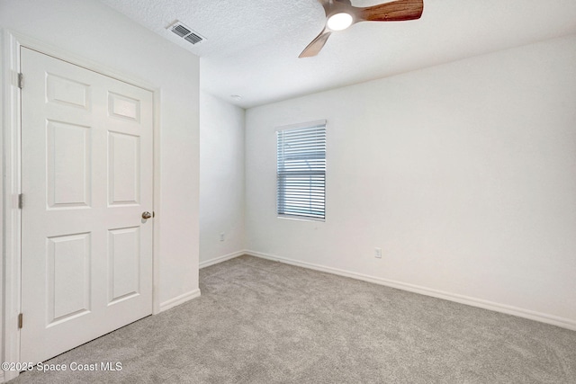 1217 Casey Ave, Rockledge, FL 32955 - empty room with light colored carpet, a ceiling fan, and a textured ceiling
