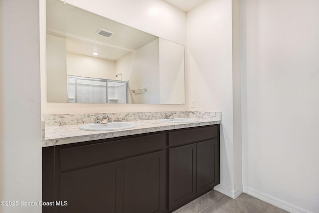 1217 Casey Ave, Rockledge, FL 32955 - bathroom featuring a shower stall, double vanity, and tile patterned floors