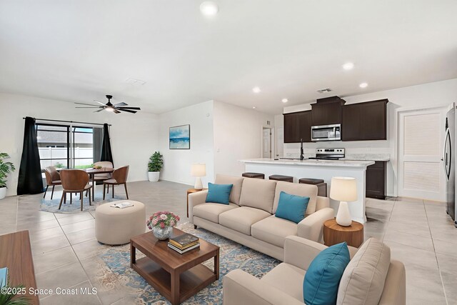 1217 Casey Ave, Rockledge, FL 32955 - living area with light tile patterned floors, a ceiling fan, and recessed lighting