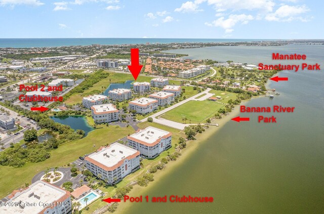 8903 Laguna Ln Unit 403, Cape Canaveral, FL 32920 - bird's eye view of apartment complex and a nearby body of water