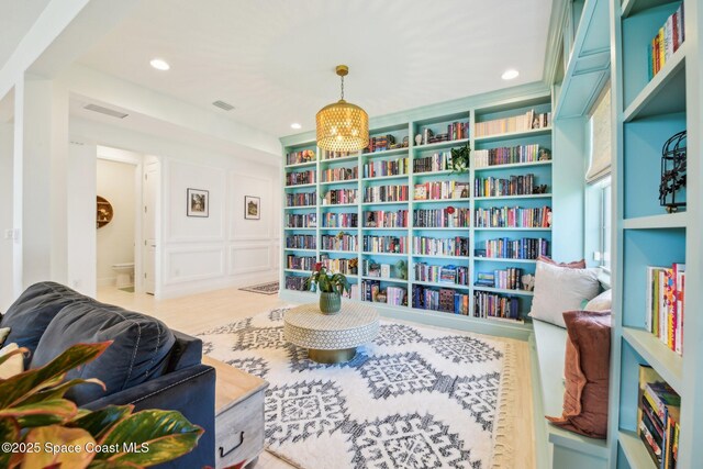2257 Kamin Dr, Melbourne, FL 32940 - living area with a decorative wall, visible vents, recessed lighting, and a chandelier