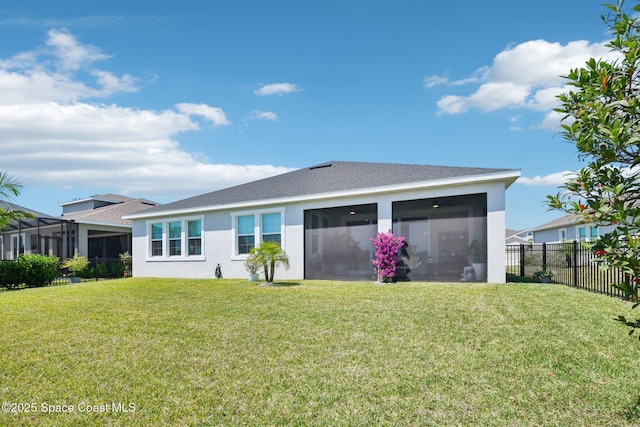 2257 Kamin Dr, Melbourne, FL 32940 - rear view of house featuring a yard, fence, a sunroom, and stucco siding