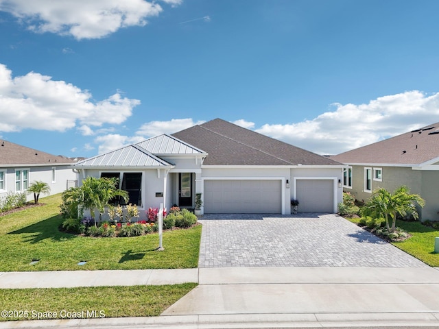2257 Kamin Dr, Melbourne, FL 32940 - single story home with an attached garage, decorative driveway, a front lawn, and stucco siding