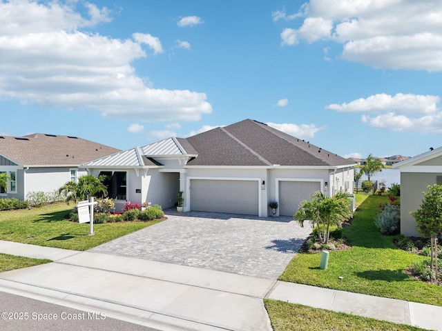 2257 Kamin Dr, Melbourne, FL 32940 - ranch-style house with a front yard, a garage, decorative driveway, and stucco siding