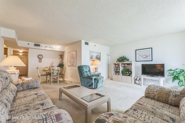 carpeted living room featuring visible vents and a textured ceiling
