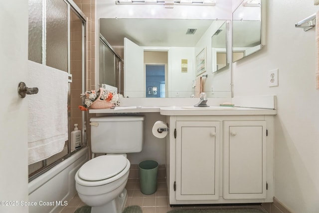 full bath featuring shower / bath combination with glass door, vanity, tile patterned flooring, toilet, and visible vents