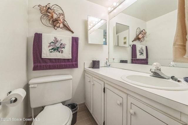 half bath featuring toilet, tile patterned floors, and vanity