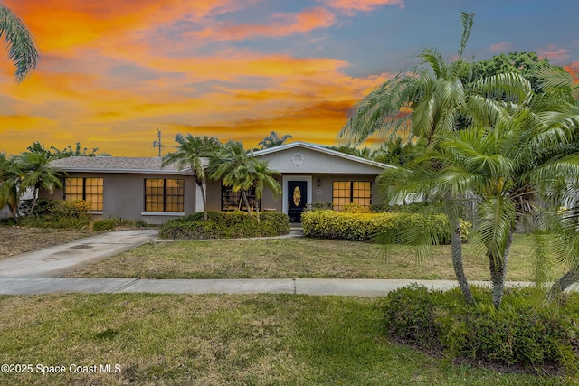 2180 Lakeview Dr, Melbourne, FL 32935 - view of front facade featuring a yard and stucco siding