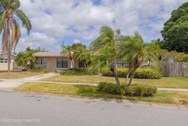 2180 Lakeview Dr, Melbourne, FL 32935 - view of front facade featuring a front lawn, fence, and stucco siding