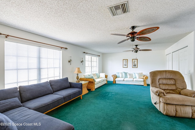 2180 Lakeview Dr, Melbourne, FL 32935 - living room featuring a textured ceiling, visible vents, ceiling fan, and carpet flooring