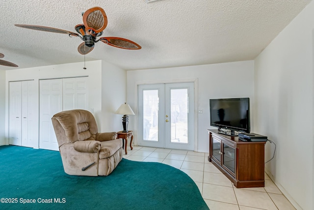 2180 Lakeview Dr, Melbourne, FL 32935 - sitting room with light tile patterned floors, ceiling fan, a textured ceiling, and french doors