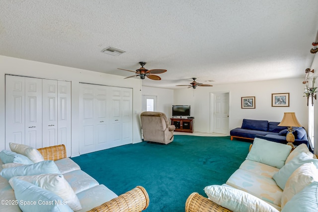 2180 Lakeview Dr, Melbourne, FL 32935 - carpeted living area with visible vents, a ceiling fan, and a textured ceiling