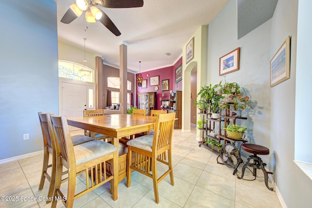 1772 Windbrook Dr SE, Palm Bay, FL 32909 - dining space featuring baseboards, arched walkways, a ceiling fan, and light tile patterned floors