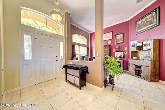 1772 Windbrook Dr SE, Palm Bay, FL 32909 - foyer entrance featuring tile patterned floors, baseboards, a high ceiling, and crown molding