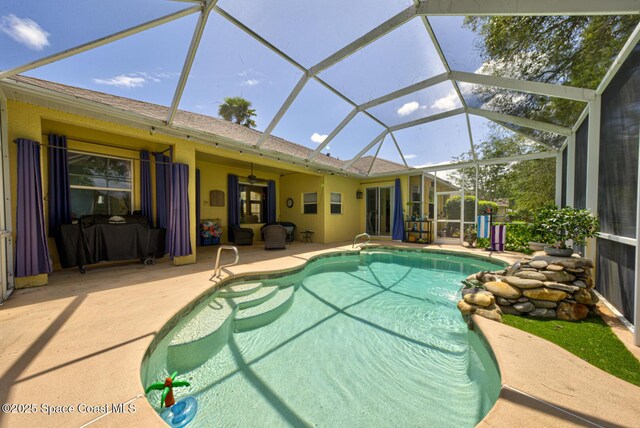 1772 Windbrook Dr SE, Palm Bay, FL 32909 - outdoor pool featuring a patio area, a ceiling fan, and glass enclosure