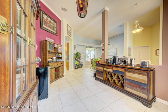 1772 Windbrook Dr SE, Palm Bay, FL 32909 - entrance foyer with baseboards, visible vents, arched walkways, and light tile patterned floors