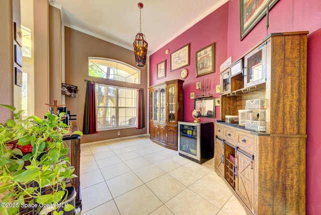 1772 Windbrook Dr SE, Palm Bay, FL 32909 - foyer with baseboards, a towering ceiling, ornamental molding, and light tile patterned flooring
