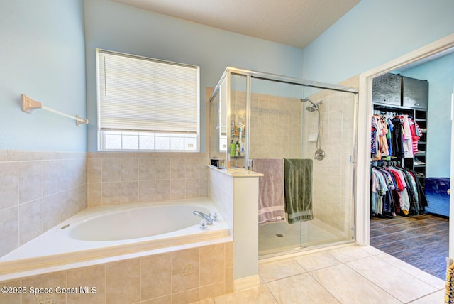 1772 Windbrook Dr SE, Palm Bay, FL 32909 - bathroom with a shower stall, a bath, tile patterned flooring, and a spacious closet