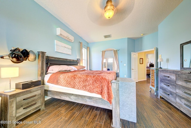 1772 Windbrook Dr SE, Palm Bay, FL 32909 - bedroom featuring a wall mounted air conditioner, a ceiling fan, dark wood-style flooring, and visible vents