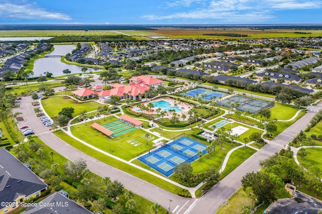 drone / aerial view featuring a residential view and a water view
