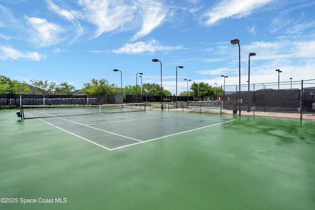 view of tennis court featuring fence