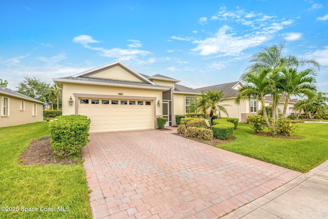 single story home with a front lawn, a garage, decorative driveway, and stucco siding
