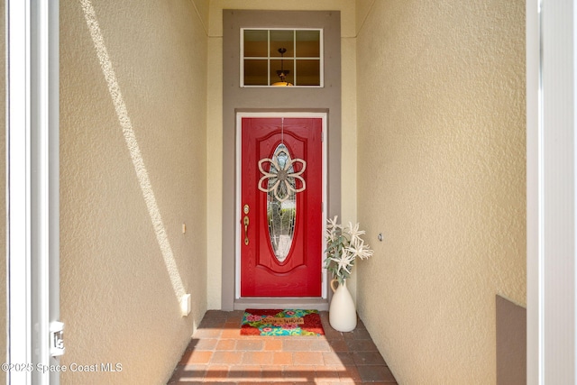 property entrance featuring stucco siding