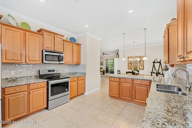 kitchen with tasteful backsplash, light tile patterned floors, a sink, appliances with stainless steel finishes, and a peninsula