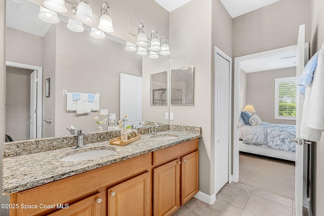 full bath with a sink, ensuite bathroom, tile patterned floors, and double vanity