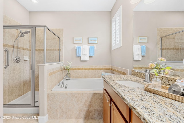 full bathroom featuring tile patterned floors, vanity, a bath, and a stall shower