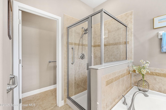 bathroom featuring tile patterned floors, a garden tub, and a stall shower