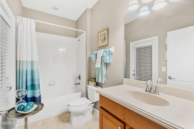 full bath featuring an inviting chandelier, vanity, toilet, shower / bath combo, and tile patterned floors