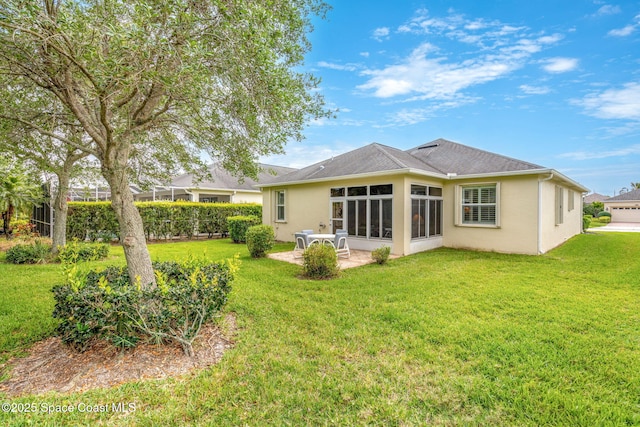 back of property featuring a patio area, stucco siding, and a lawn