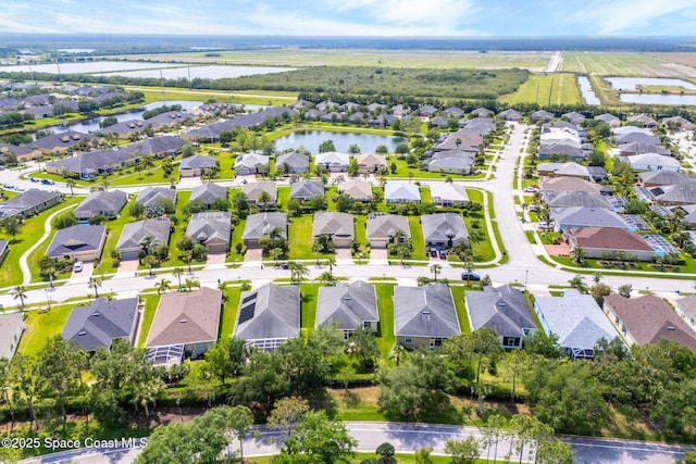 birds eye view of property with a water view and a residential view