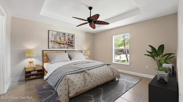 bedroom with baseboards, a raised ceiling, ceiling fan, and light tile patterned flooring