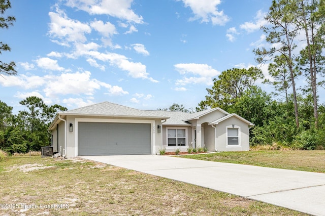 ranch-style home featuring stucco siding, driveway, a front yard, and a garage