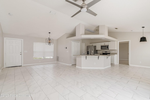 unfurnished living room with vaulted ceiling, visible vents, baseboards, and ceiling fan with notable chandelier