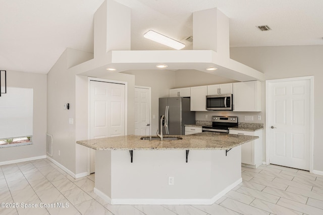 kitchen with marble finish floor, baseboards, stainless steel appliances, and a sink