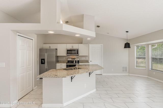 kitchen featuring a sink, vaulted ceiling, visible vents, white cabinetry, and appliances with stainless steel finishes